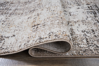 Beige and gray area rug edge with low-profile pile and visible binding