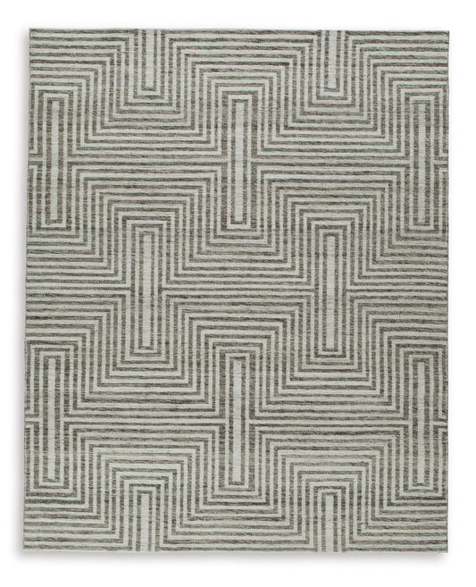 Gray and cream geometric area rug with repeating maze pattern, visible woven edge.