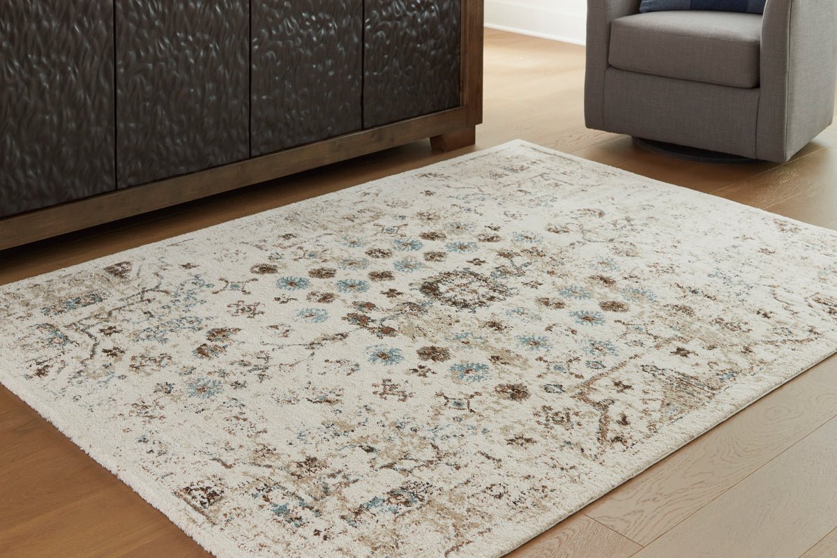 Cream rug with teal and brown distressed pattern, flat woven texture