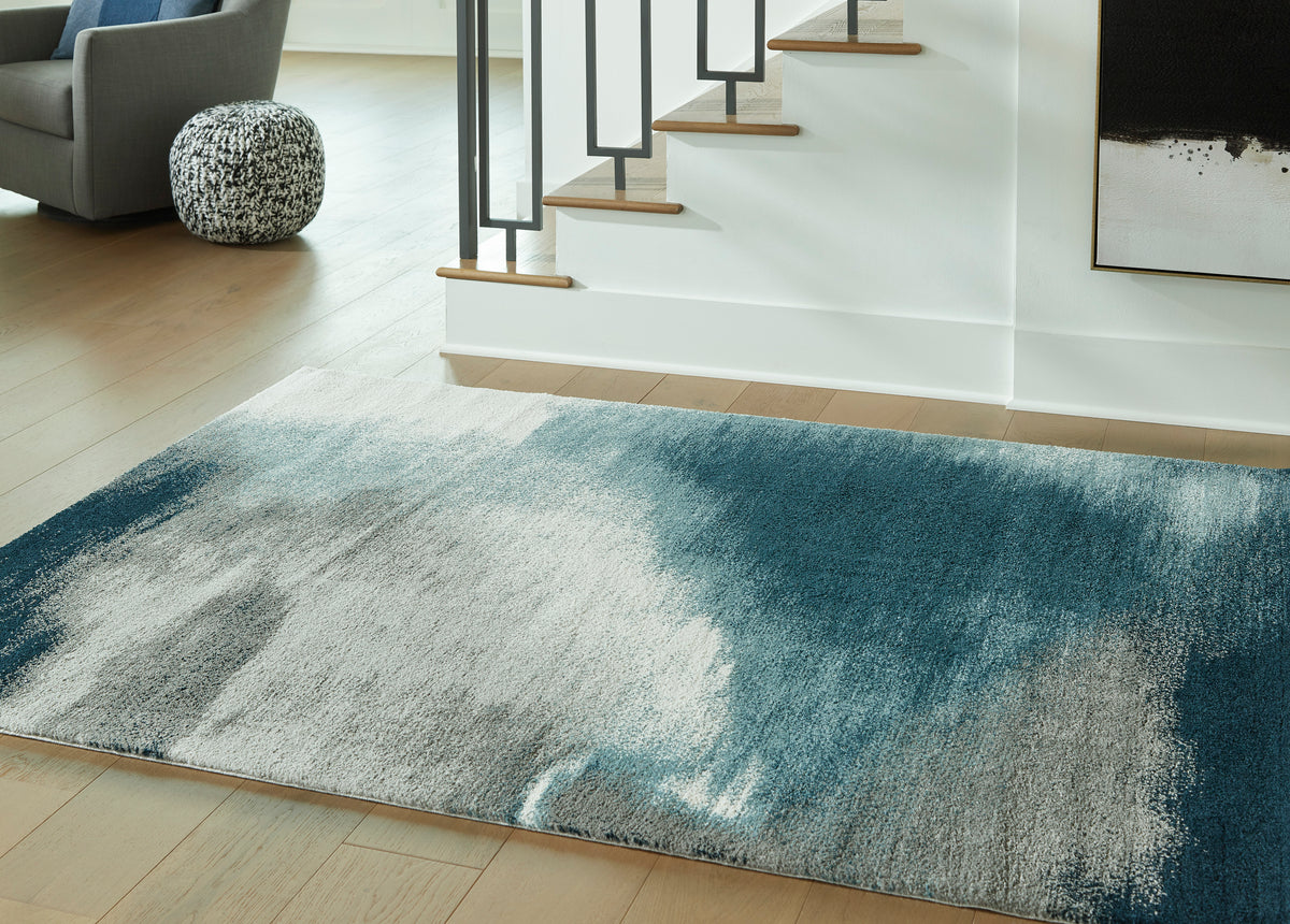Abstract area rug with blue-gray and light beige textured pattern, rectangular.