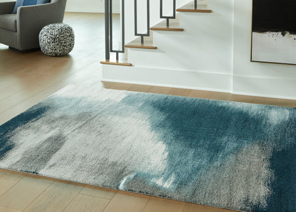 Abstract area rug with blue-gray and light beige textured pattern, rectangular.