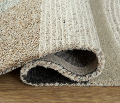 Woven area rug edge with fringe and looped texture in cream and gray