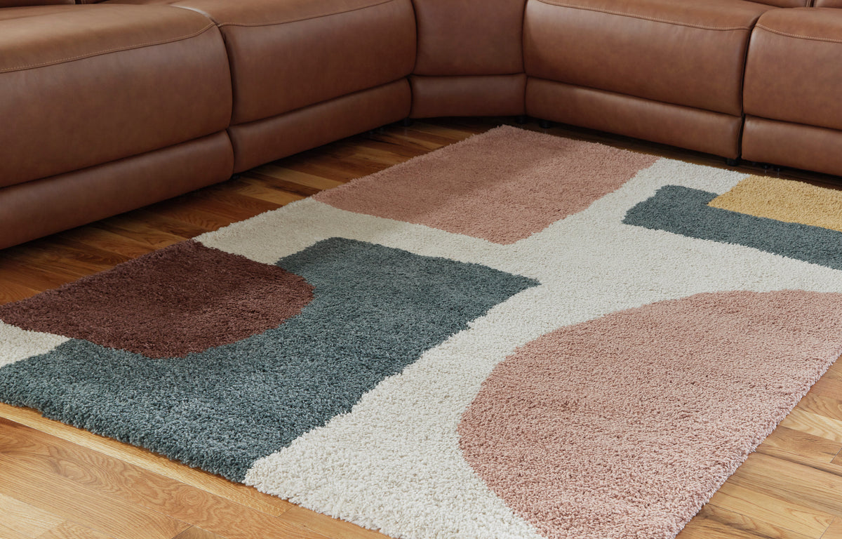Geometric area rug with tan, teal, cream and brown abstract blocks