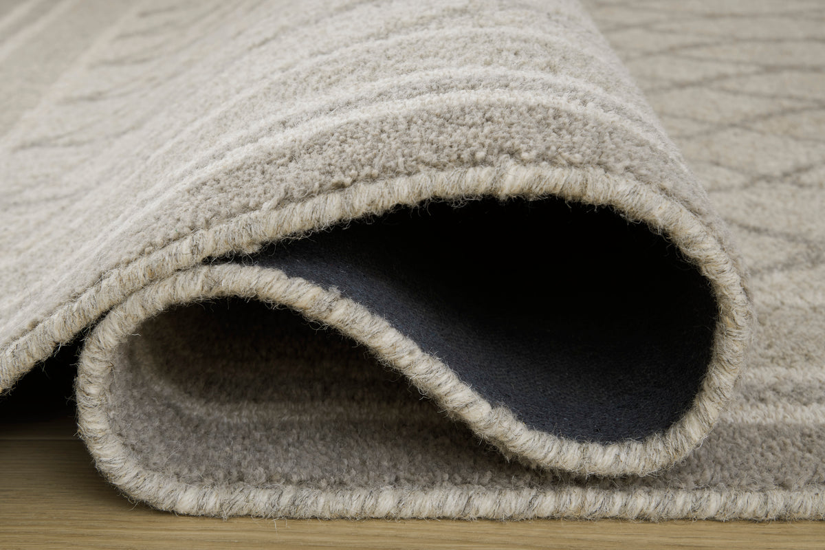 Ashley Wimney rug close-up, light gray bound edge with dark underside