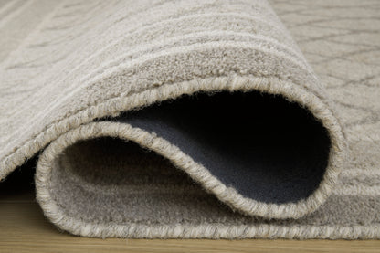 Ashley Wimney rug close-up, light gray bound edge with dark underside