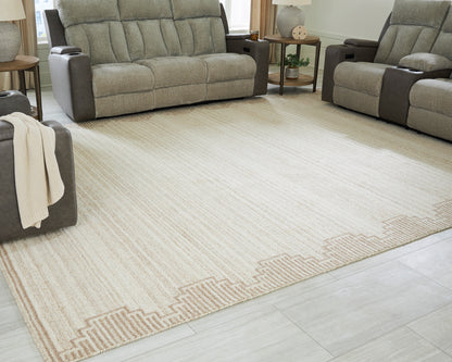 Cream flatweave area rug with subtle stripes and tan geometric border