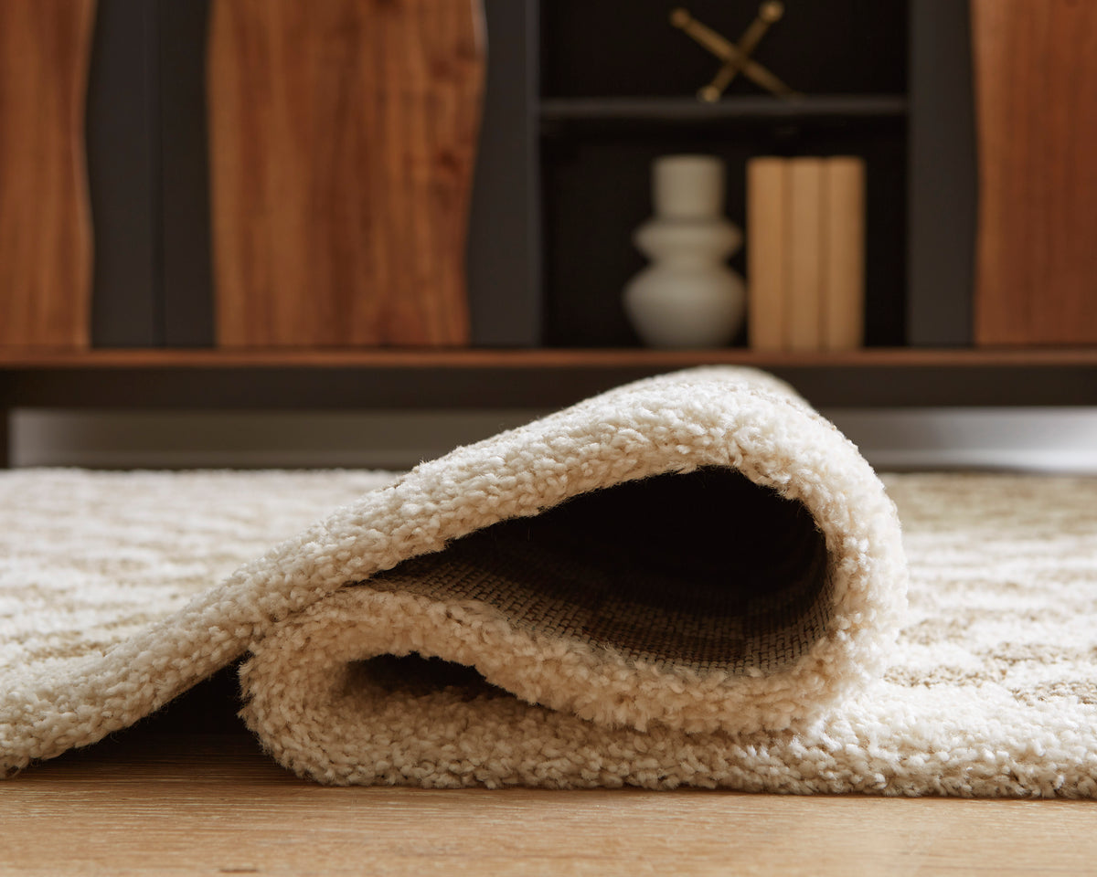 Karamen medium rug close-up: curved edge showing textured looped pile.