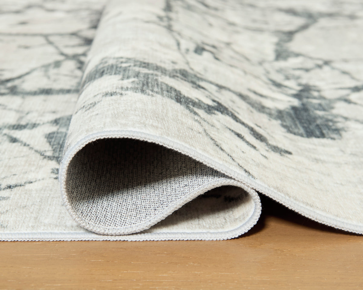 Ashley Tobinbury Washable Rug folded to show its woven backing and bound edge