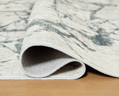 Ashley Tobinbury Washable Rug folded to show its woven backing and bound edge