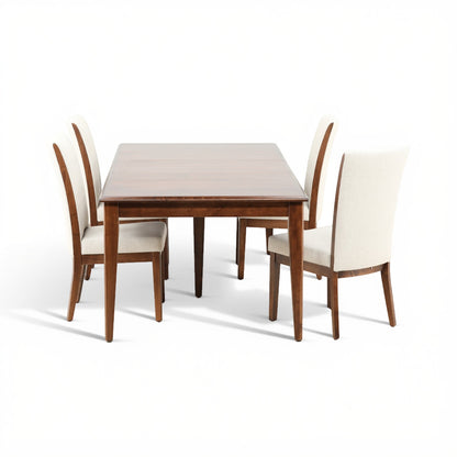 View of wooden dining table and four cream upholstered chairs, five-piece set