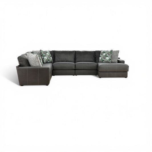 Dark gray sectional with left chaise and camo accent pillows, plus gray throw pillows