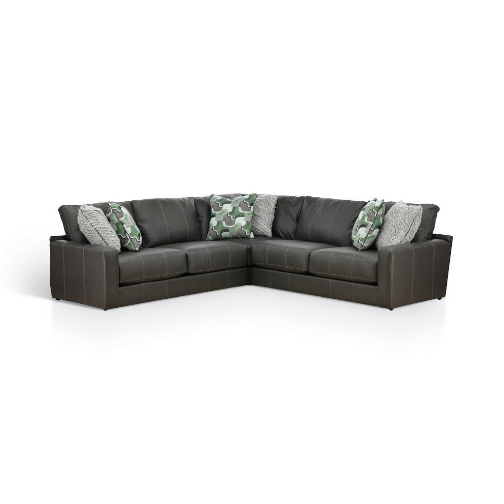Dark gray L-shaped sectional sofa with green camo and textured gray pillows