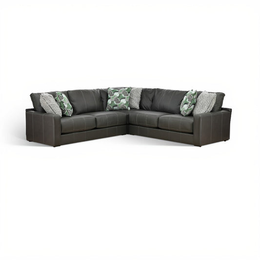 Dark gray 3-piece sectional sofa with green camo and gray accent pillows