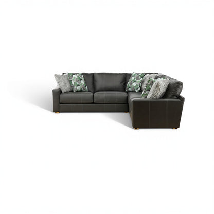 Dark gray sectional with right chaise, green camo pillows, and gray throw