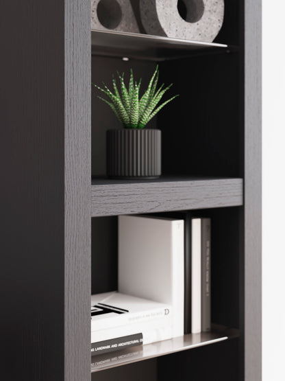 Black open shelving unit with books and potted plant
