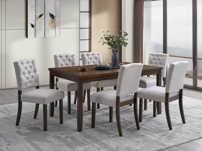 Five white tufted dining chairs around a dark wood table