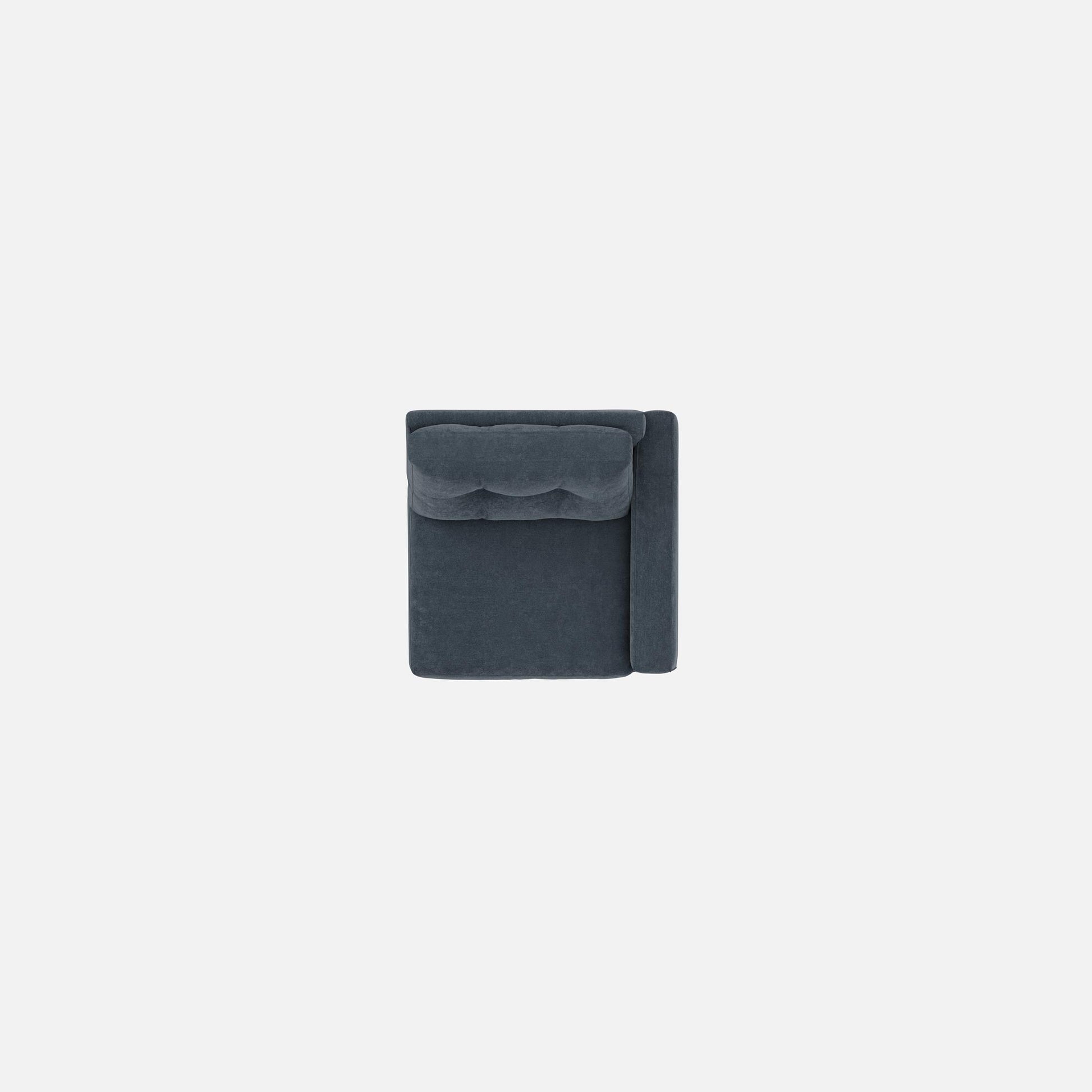 Upholstered armchair in dark navy, close view of backrest with tufted cushioning