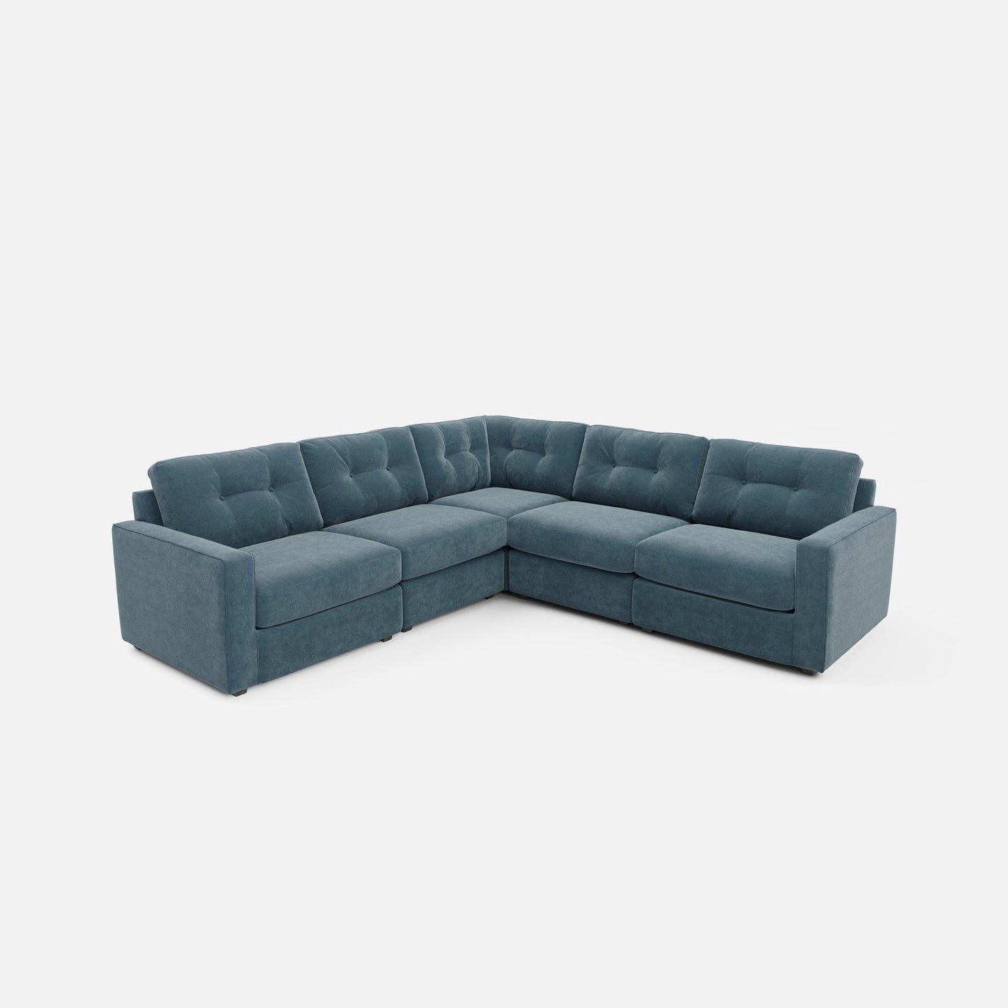 Teal modular sectional sofa with tufted back and chaise-style corner.