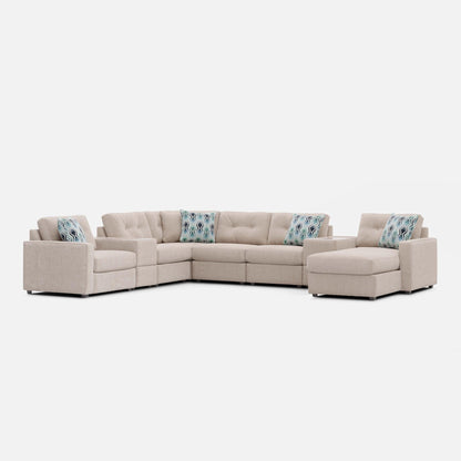 Light beige modular sectional sofa with patterned accent pillows on back cushions.