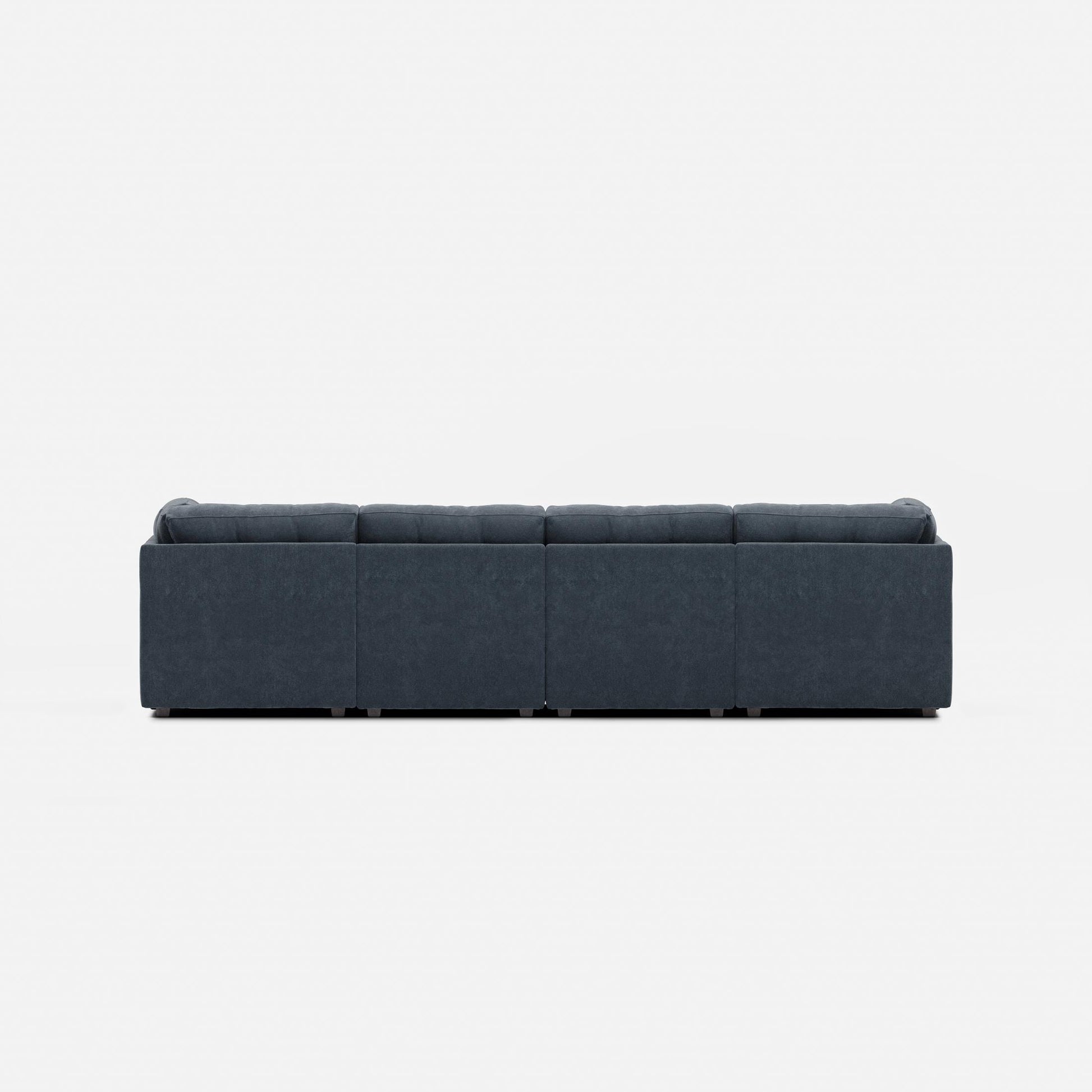 Navy fabric modular sectional sofa with padded arms, back, and four seat blocks