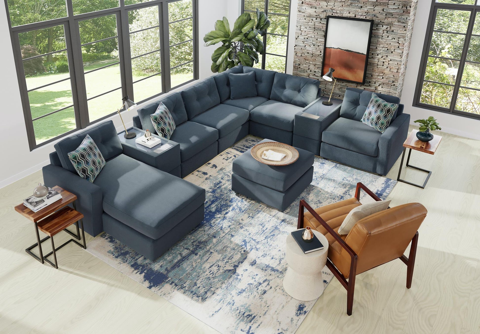 Dark gray modular sectional sofa with patterned throw pillows and chaise ottoman