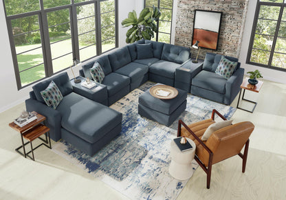 Dark gray modular sectional sofa with patterned throw pillows and chaise ottoman