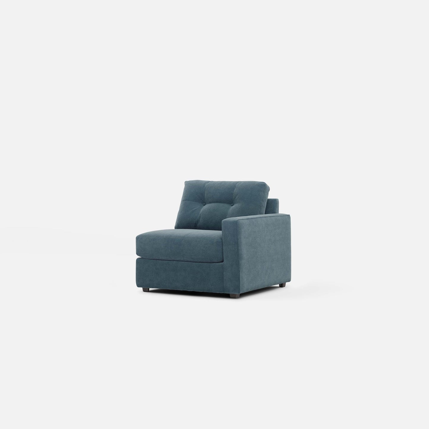 Modular chair in teal fabric shown at angle with thick seat and sloped armrest.