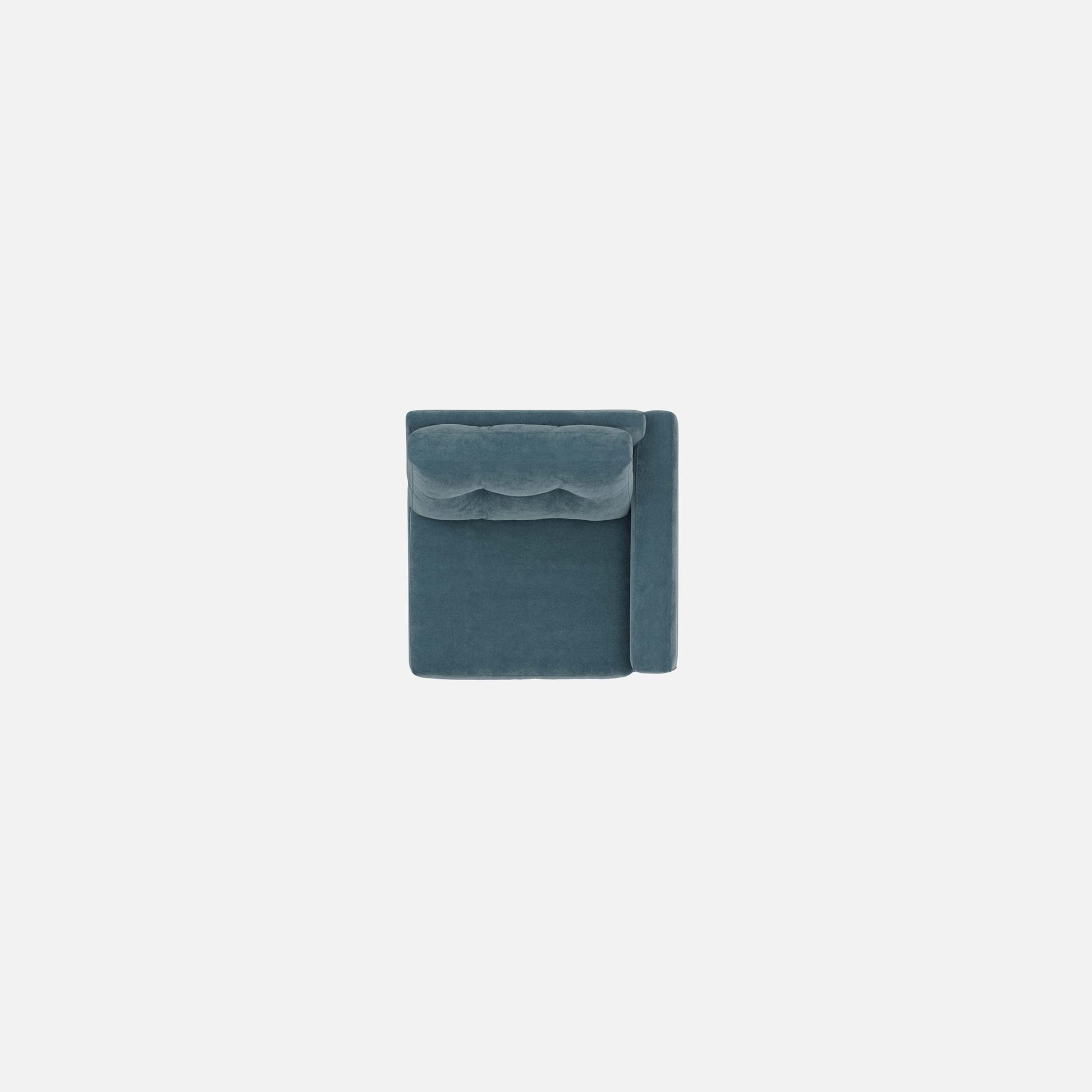 Modular chair corner view in teal fabric with tufted back top seam.