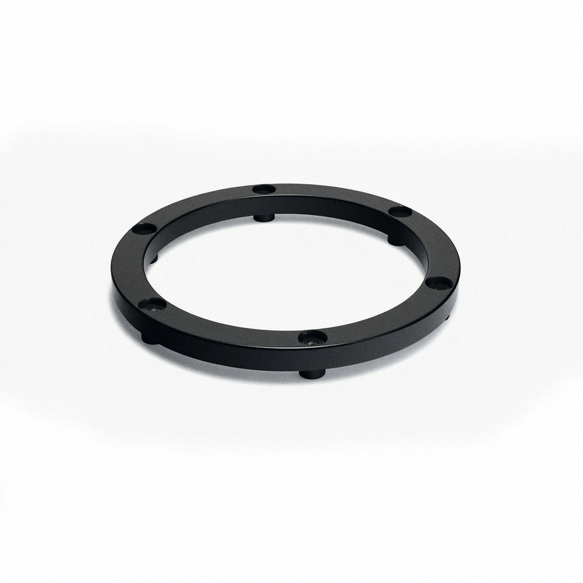 Black circular elevator ring base with four small legs and mounting holes
