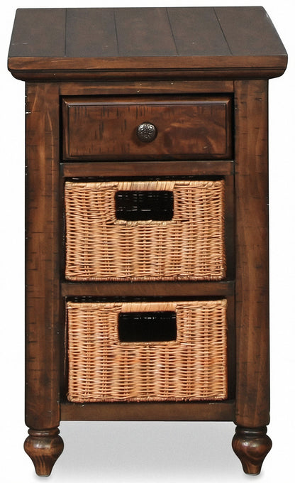 Wooden chairside end table with dark top, drawer knob, and two wicker storage bins
