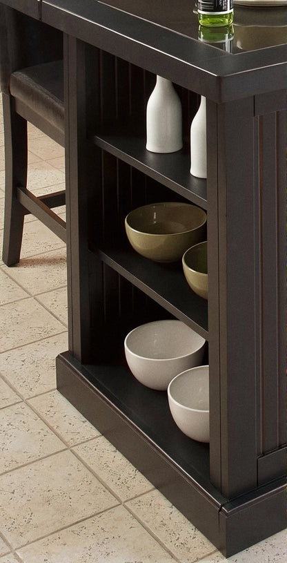Dark kitchen island with open shelves holding ceramic bowls and a vase