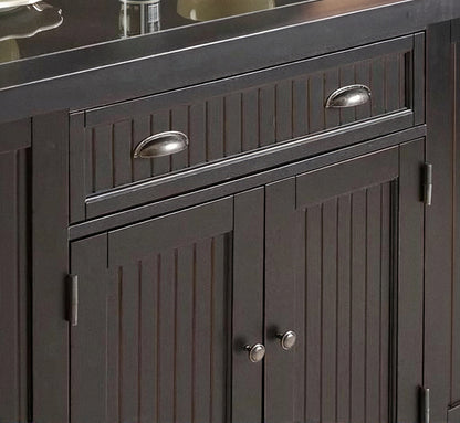 Dark kitchen island cabinet with paneled doors, drawers, and silver metal handles