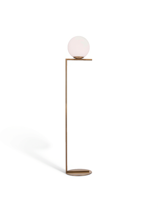 Brass floor lamp with frosted globe shade and round base