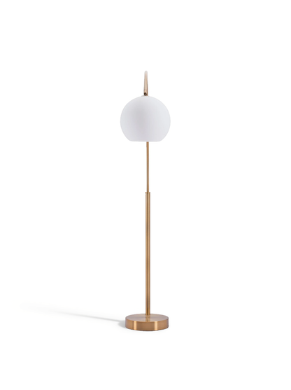 Brass floor lamp with round frosted globe shade on slim cylindrical stand