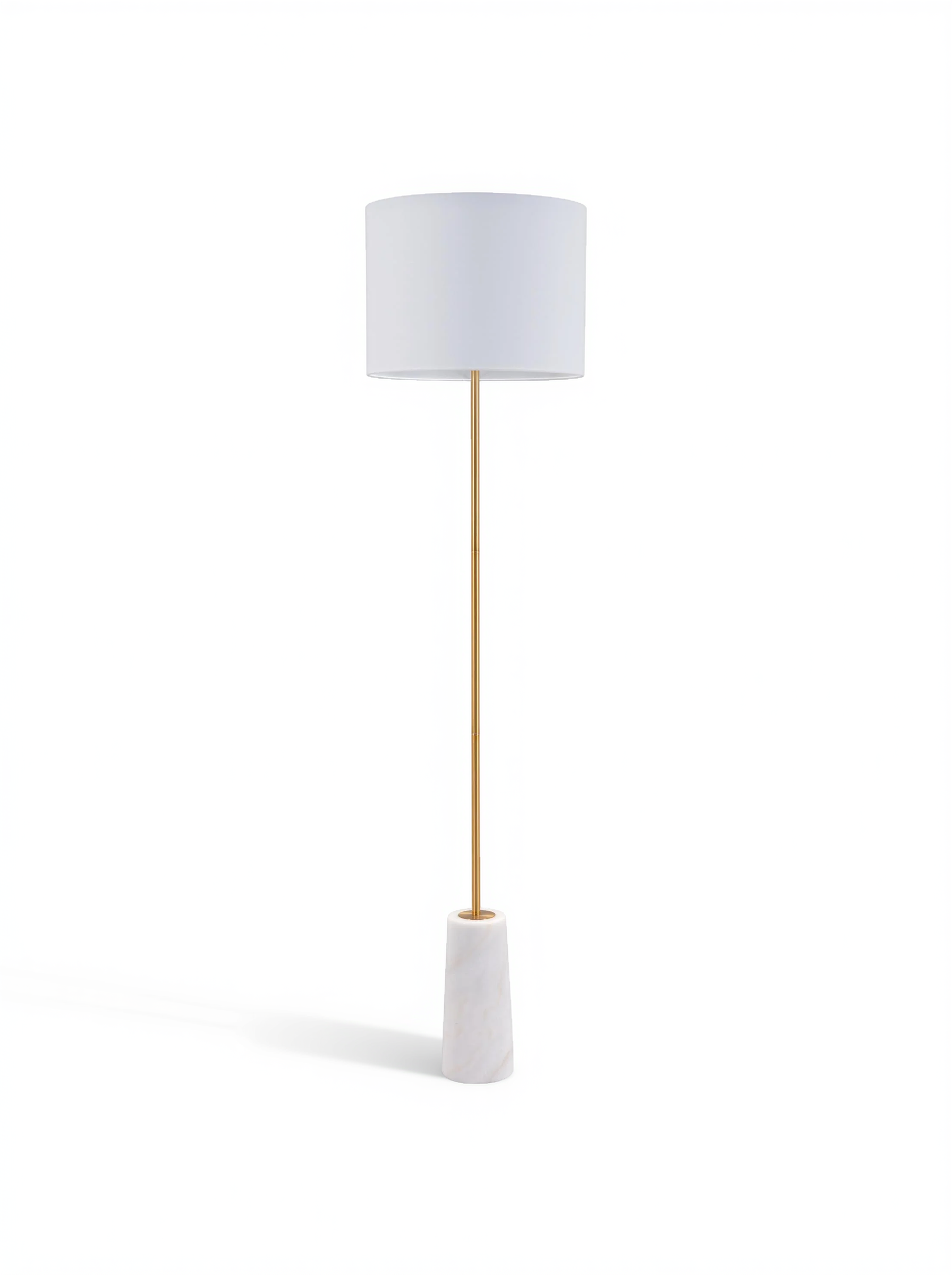 White fabric drum floor lamp with slender brass pole and white base.