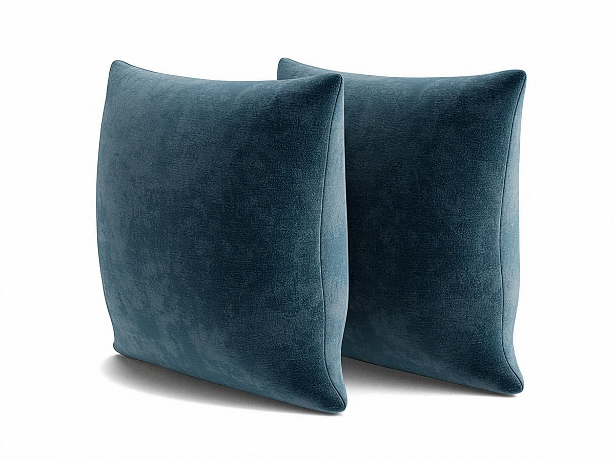 Blue square throw pillows with knife-edge seams, 22 x 22 in, angled view