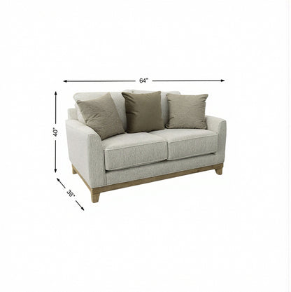 Light gray upholstered loveseat with three cushions, three pillows, and tapered dark legs