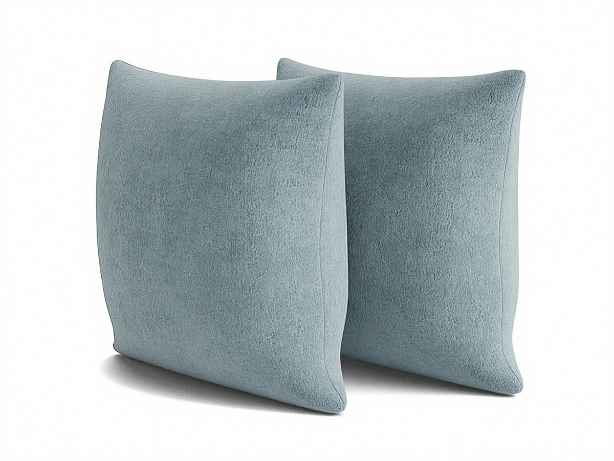 Two light blue 22" square knife-edge pillows with plush textured surfaces
