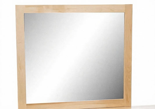 Rectangular bedroom mirror with light wood frame and silver glass